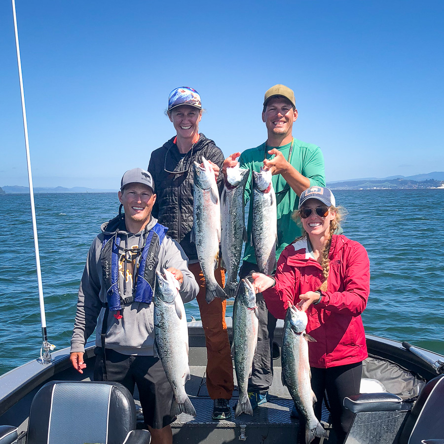 Guests of fishing guide at Buoy 10 show off their salmon they caught on the Columbia River