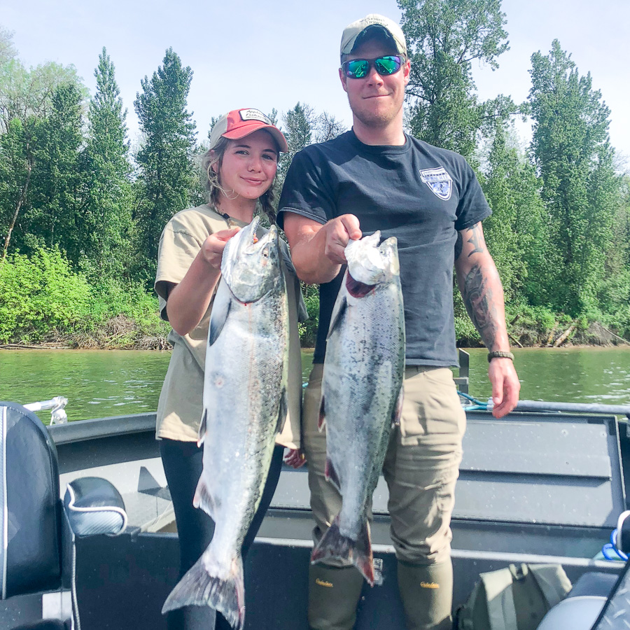 Couple holds up a Chinook salmon caught on the Columbia River on a guided fishing trip