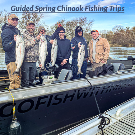 Group of six friends pose with the Chinook Salmon they caught on the Columbia River on a guided trip